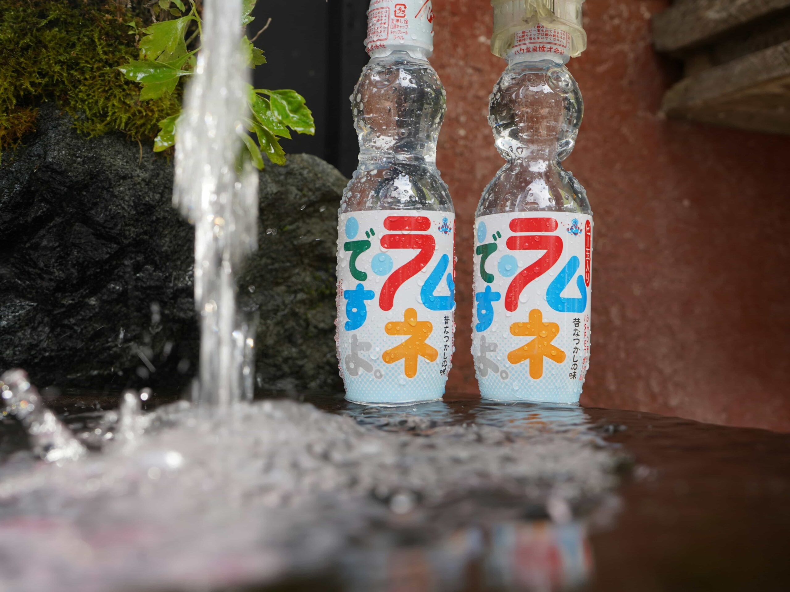 Ramune Marble Soda - 5 Two ramune bottles photographed within a fountain.