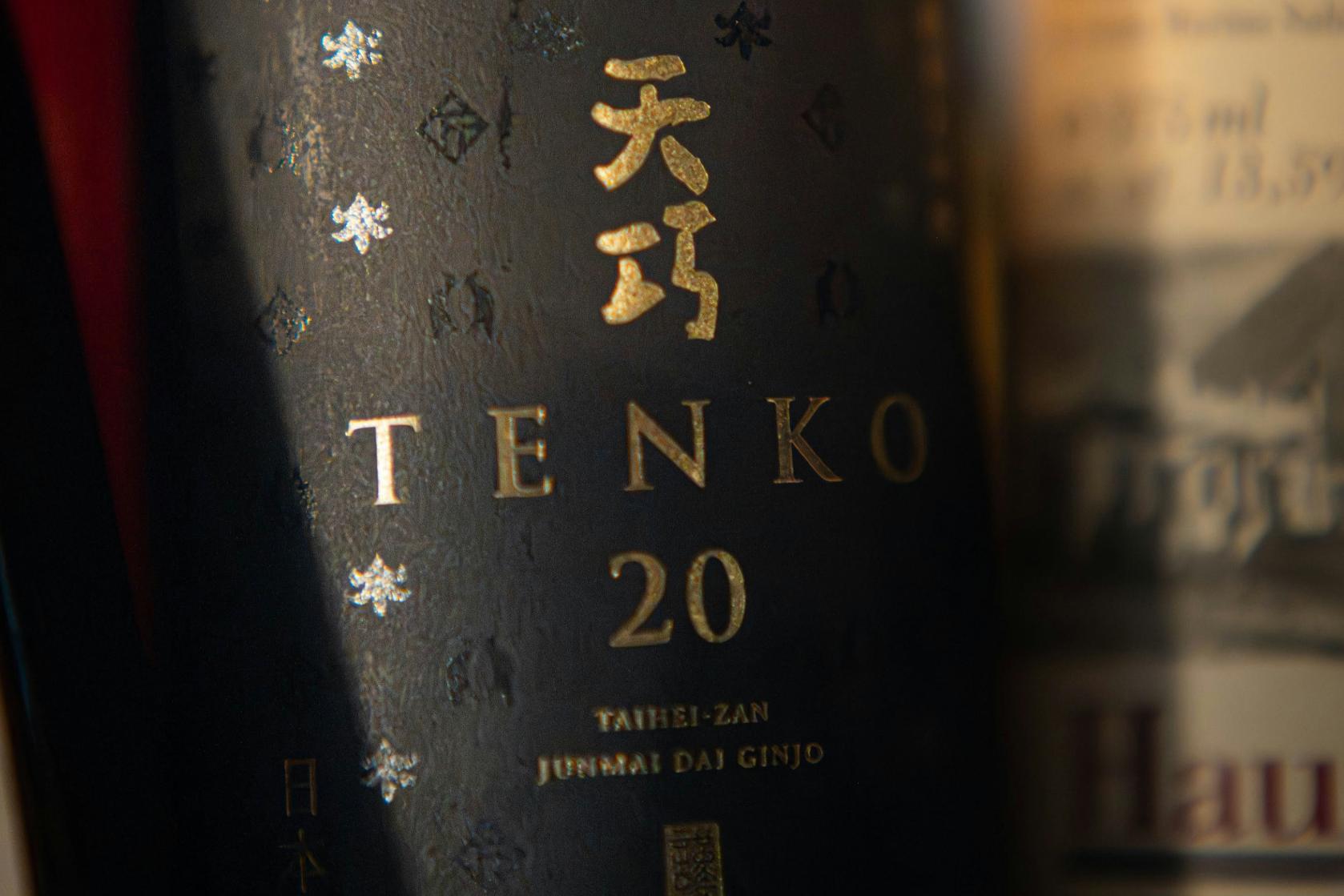 Rice WIne - 3 A close-up image of a Junmai sake on a countertop surrounded by various sake behind the bottle.