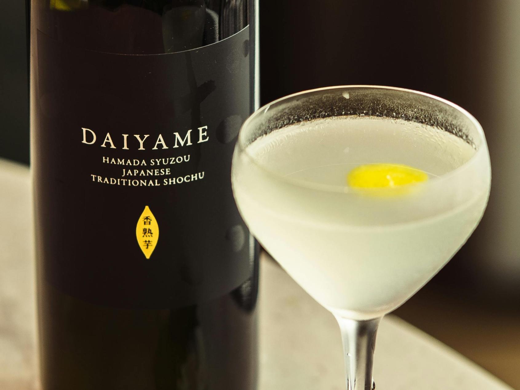 Understanding Sake - 4 A photo of a traditional shochu sake, accompanied by a chilled glass containing the beverage with a slice of lemon.