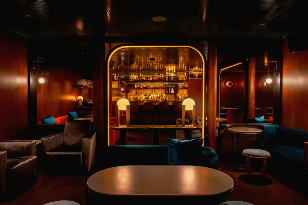Upscale bar interior with premium spirits and mood lighting.