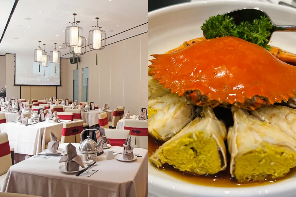 A decorated Chinese banquet hall set for a formal event next to a dish of steamed crab with yellow roe and ginger soy sauce.