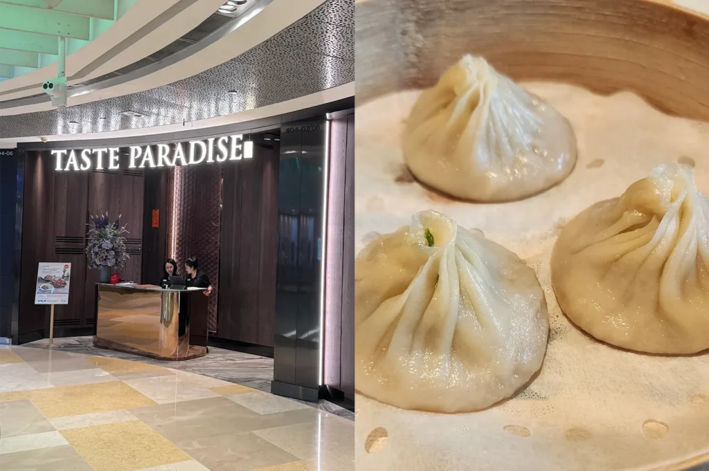 The storefront of Taste Paradise restaurant in a mall next to a bamboo steamer basket containing three delicate Xiao Long Bao (soup dumplings).