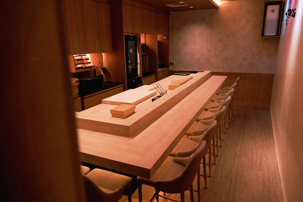 Private omakase dining room in Singapore with intimate counter seating and Japanese wood interiors