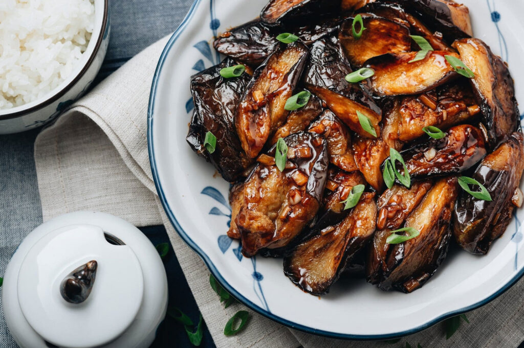 Stir-fried Chinese eggplant in dark savoury sauce with spring onions and wok-charred texture
