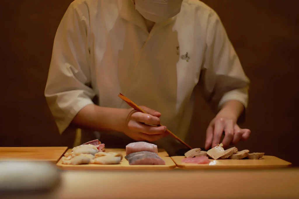 Japanese omakase chef in Singapore preparing fresh seasonal sushi and premium seafood at the counter