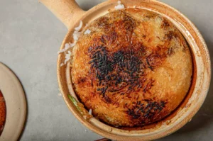 Traditional Chinese claypot rice with crispy rice crust served in a clay pot from a top view