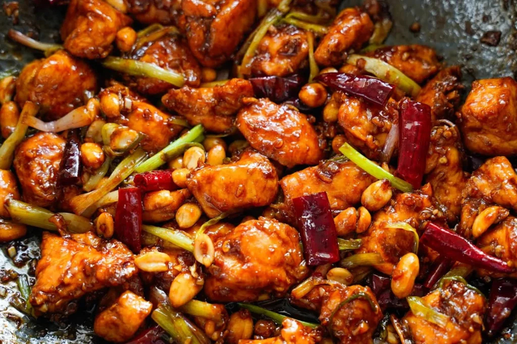 Authentic Kung Pao chicken stir-fry with roasted peanuts, dried chilies, and glossy savory sauce.