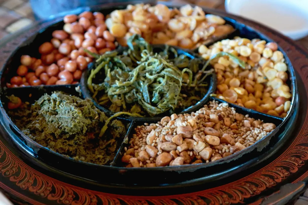Traditional Burmese tea leaf salad with sesame seeds and fermented tea leaves