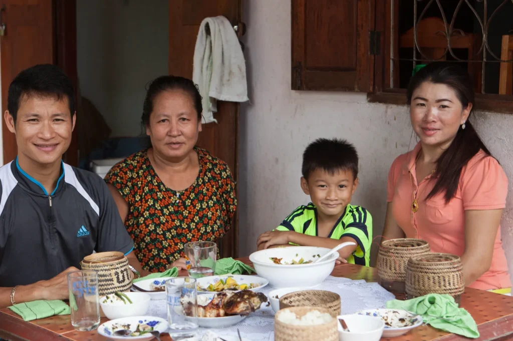 Communal Lao dining experience with sticky rice and local dishes