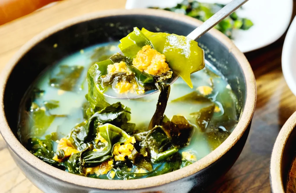 Jeju seaweed soup with fresh kelp and sea urchin, a traditional Korean seafood broth rich in ocean flavors.