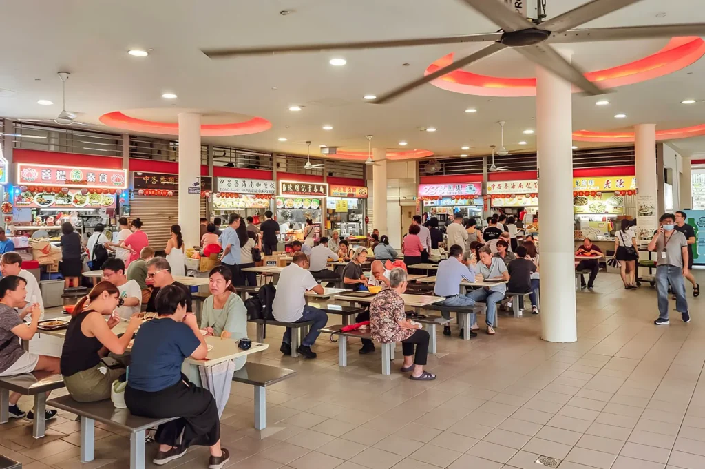 Busy Tiong Bahru Market food centre with diners enjoying Singapore hawker food and local specialties