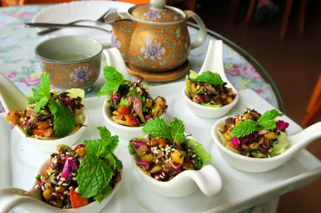 Myanmar lahpet tea leaf salad served with green tea and fresh herbs