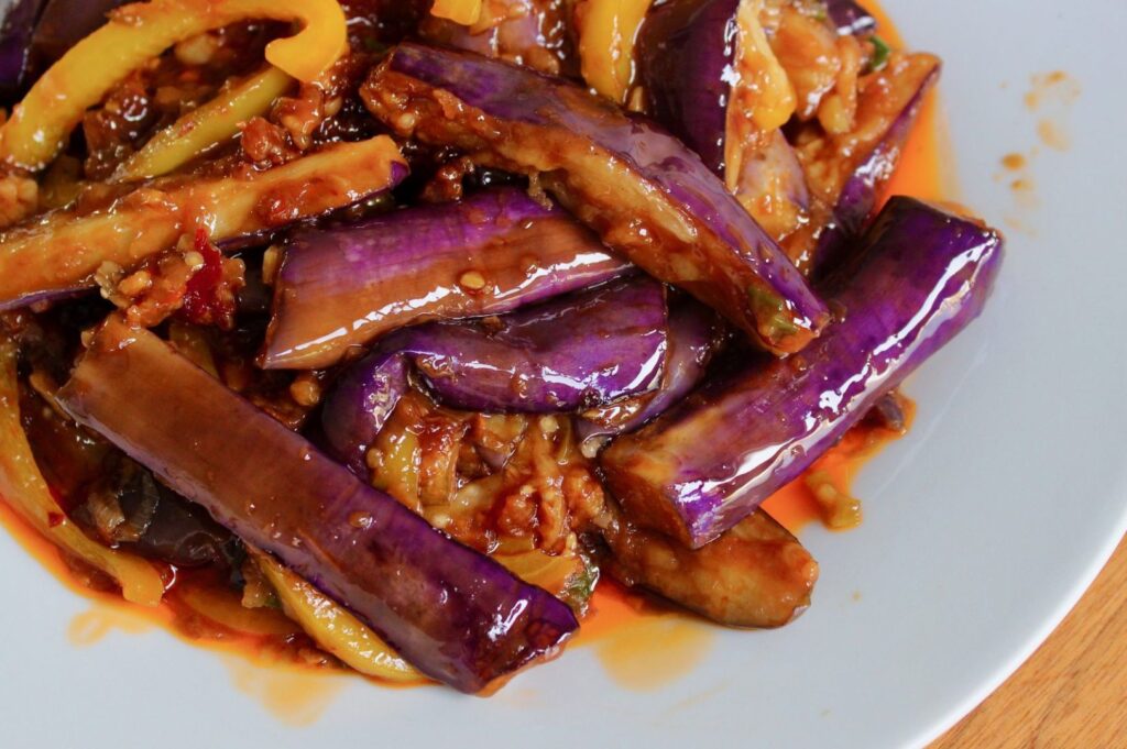 Stir-fried Chinese eggplant in glossy spicy garlic sauce with chili and minced meat served in authentic Sichuan-style presentation