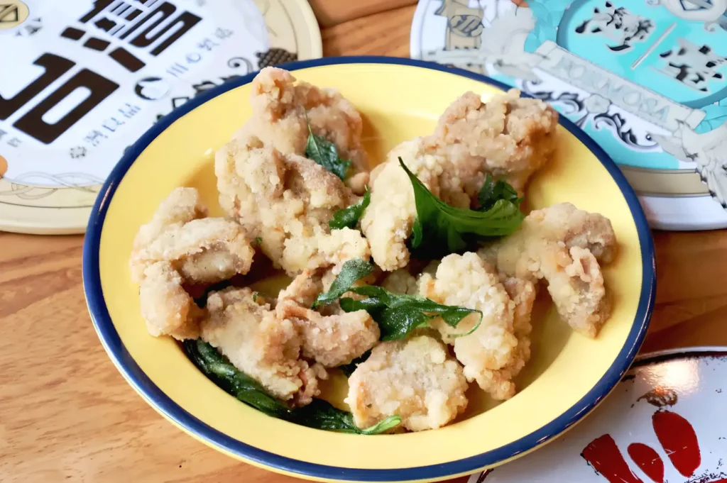 Taiwanese popcorn chicken in Singapore served with crispy basil leaves at Eat 3 Bowls Bendemeer