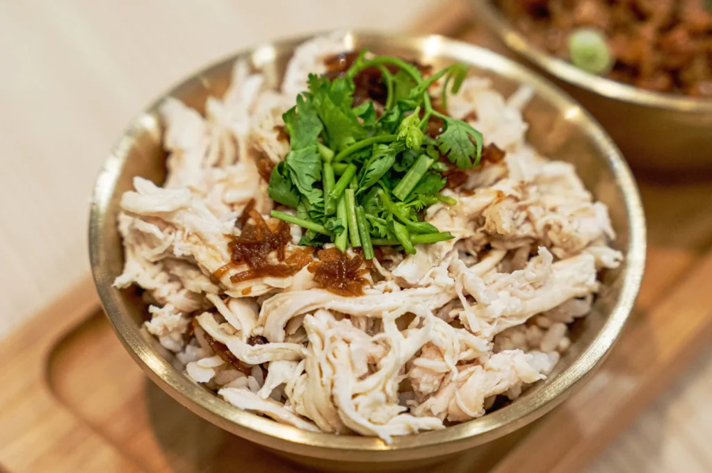Taiwanese shredded chicken rice bowl at Eat 3 Bowls Bendemeer topped with crispy shallots and fresh coriander in Singapore