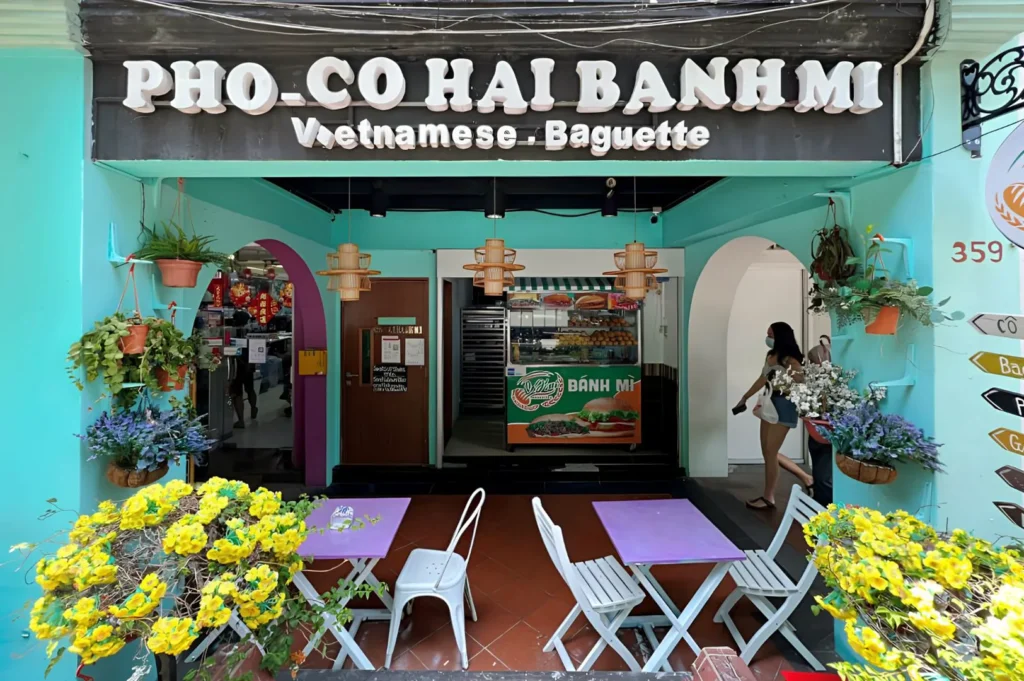 Co Hai Banh Mi Singapore storefront with outdoor seating, serving authentic Vietnamese bánh mì, pho, and fresh baguettes.