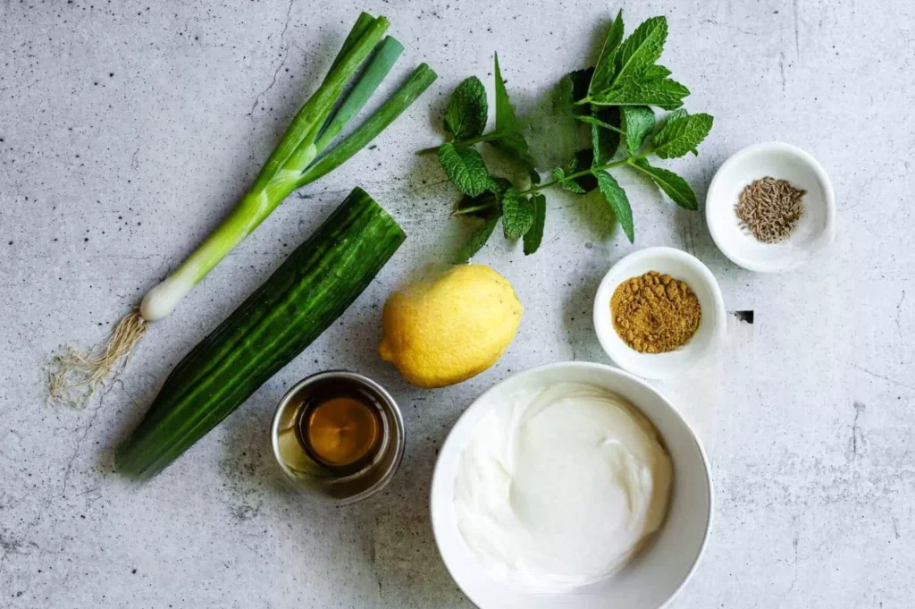 Cucumber raita ingredients with yogurt, cucumber, mint and spices