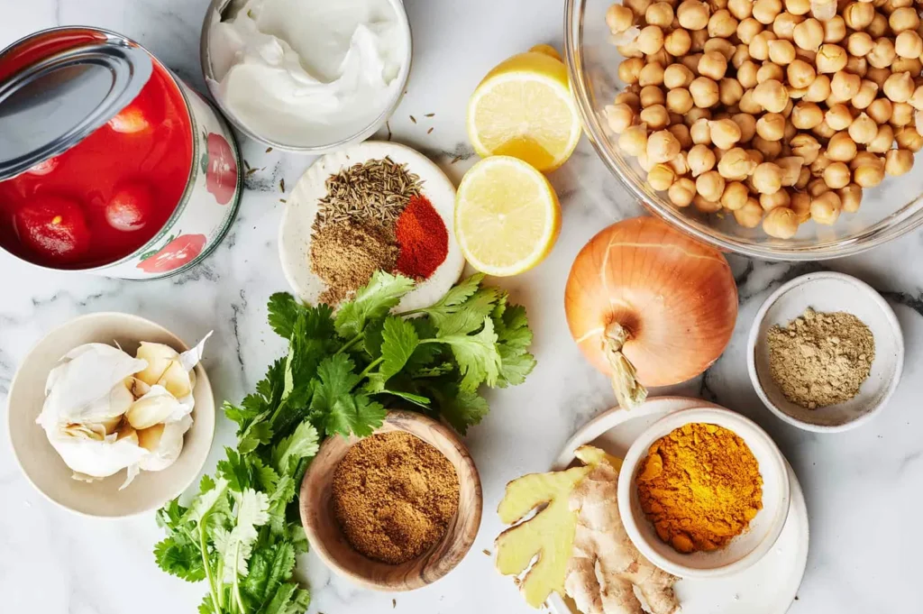 Fresh chana masala ingredients with chickpeas, tomatoes, spices and herbs