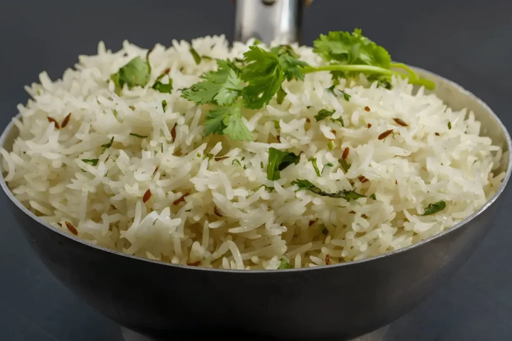 Fluffy homemade jeera rice garnished with cumin seeds and fresh cilantro