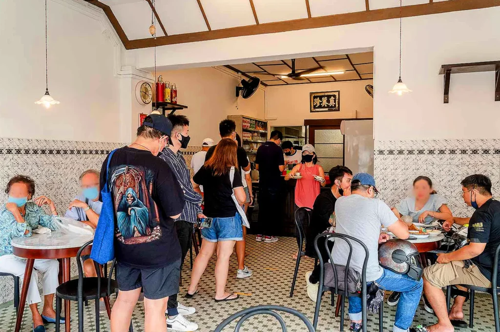Chin Mee Chin Confectionery interior with customers enjoying traditional Singaporean breakfast and kaya buns
