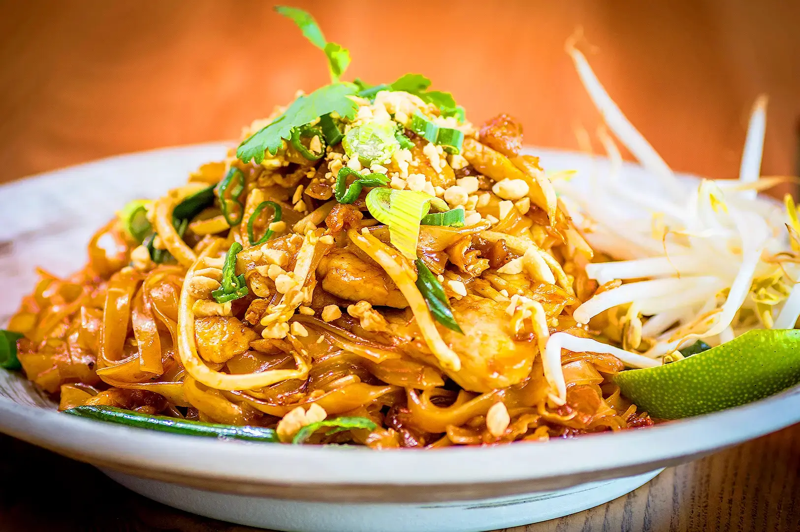 Authentic Thai Pad Thai noodles with chicken, bean sprouts, crushed peanuts, scallions, cilantro and lime