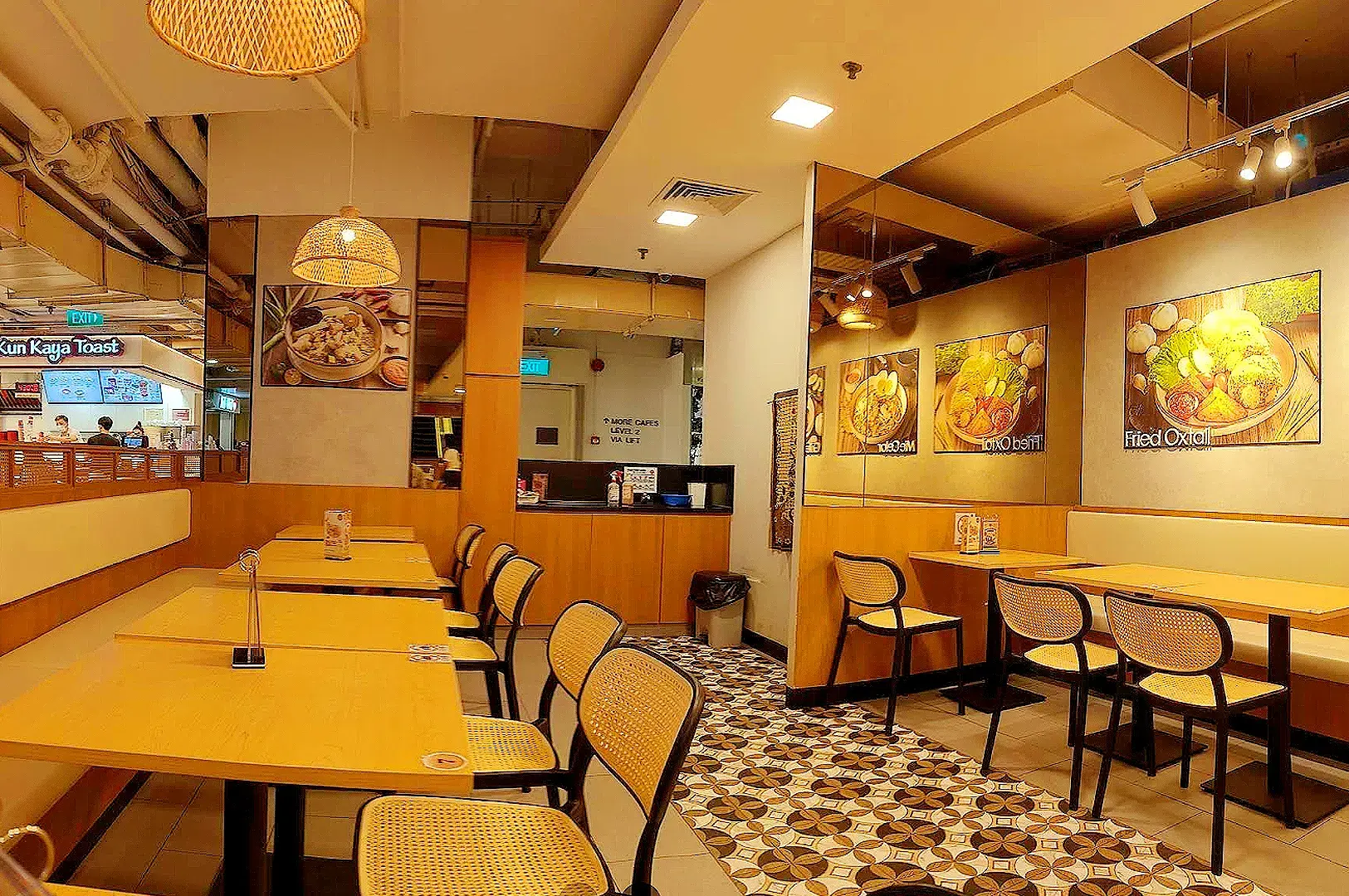Indo Rasa Singapore restaurant interior with wooden tables, rattan chairs, Indonesian food wall art and warm lighting