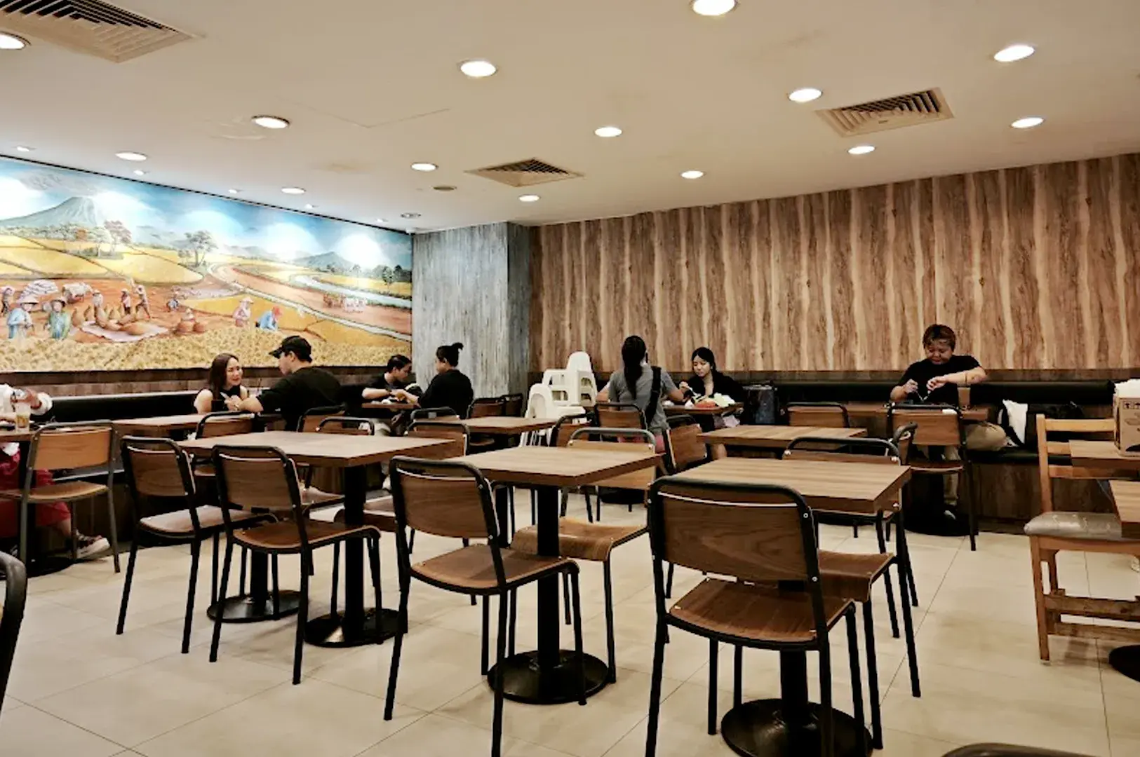 Bebek Goreng Pak Ndut restaurant interior with wooden tables, dining area, and traditional decor