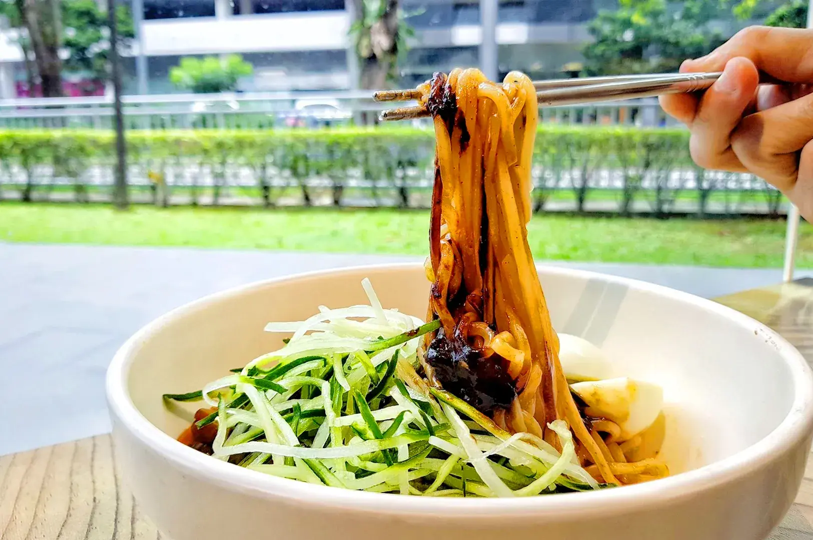 Vegetarian Korean jajangmyeon noodles at The Boneless Kitchen Singapore with fresh cucumber and black bean sauce.