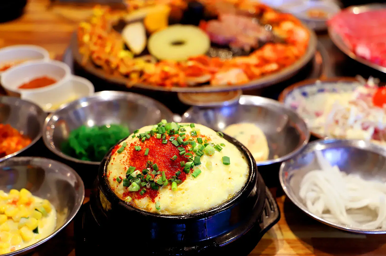 Korean steamed egg topped with red pepper and spring onions served with banchan at SBCD Korean Tofu House