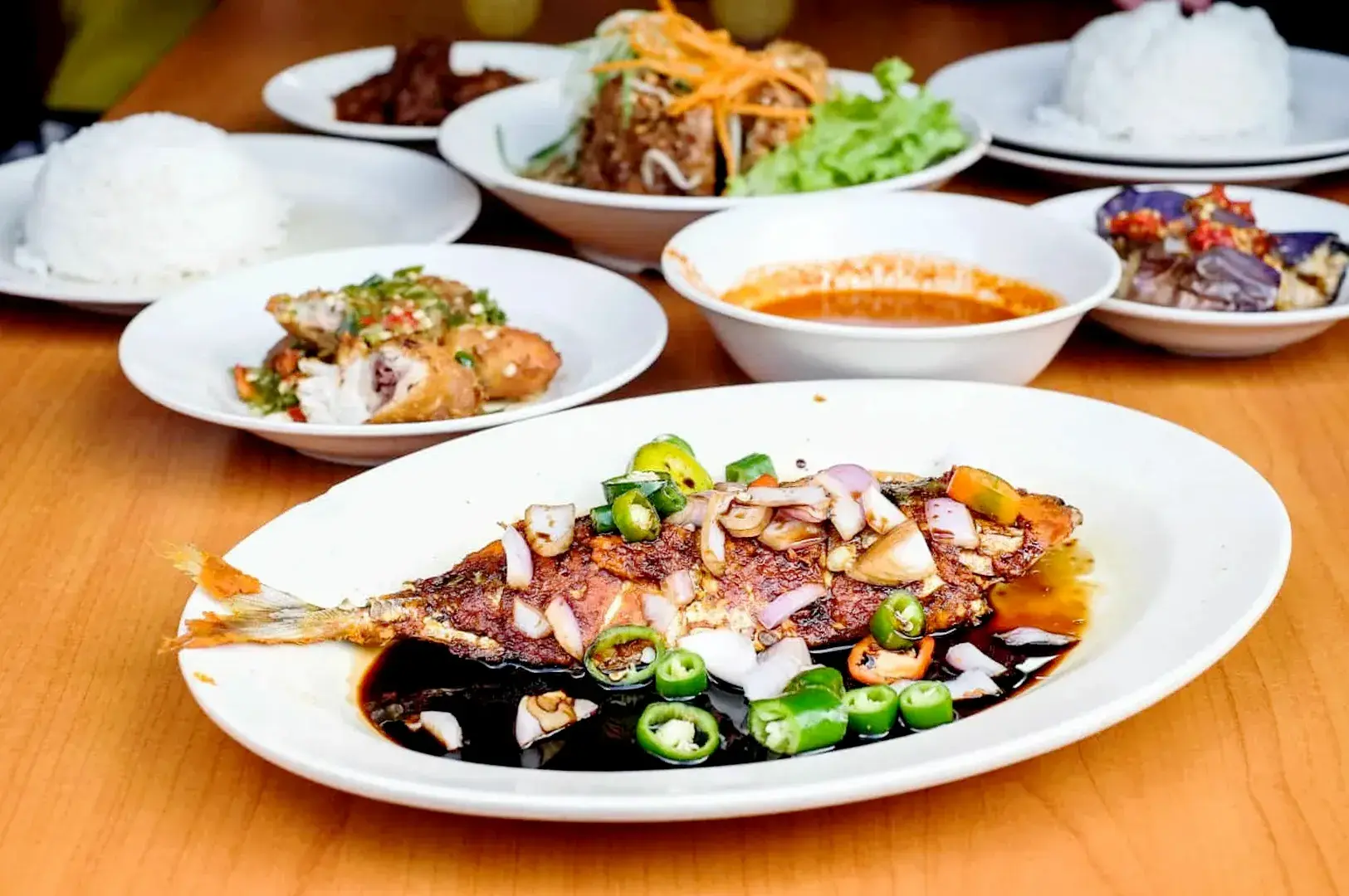 Bebek Goreng Pak Ndut fried duck served with white rice, crispy toppings, and spicy sambal
