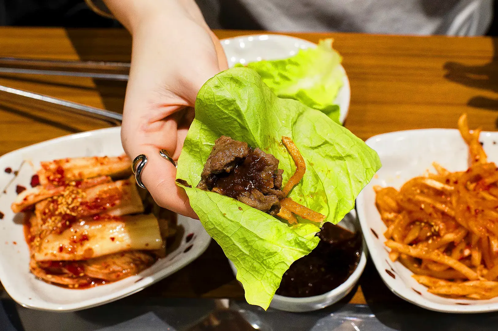 Korean lettuce wrap with grilled beef, vegetables and Korean barbecue side dishes