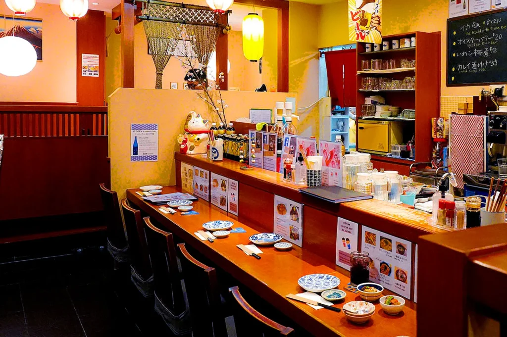Keria Japanese Restaurant interior with traditional Japanese décor, counter seating, warm lighting and dining setup