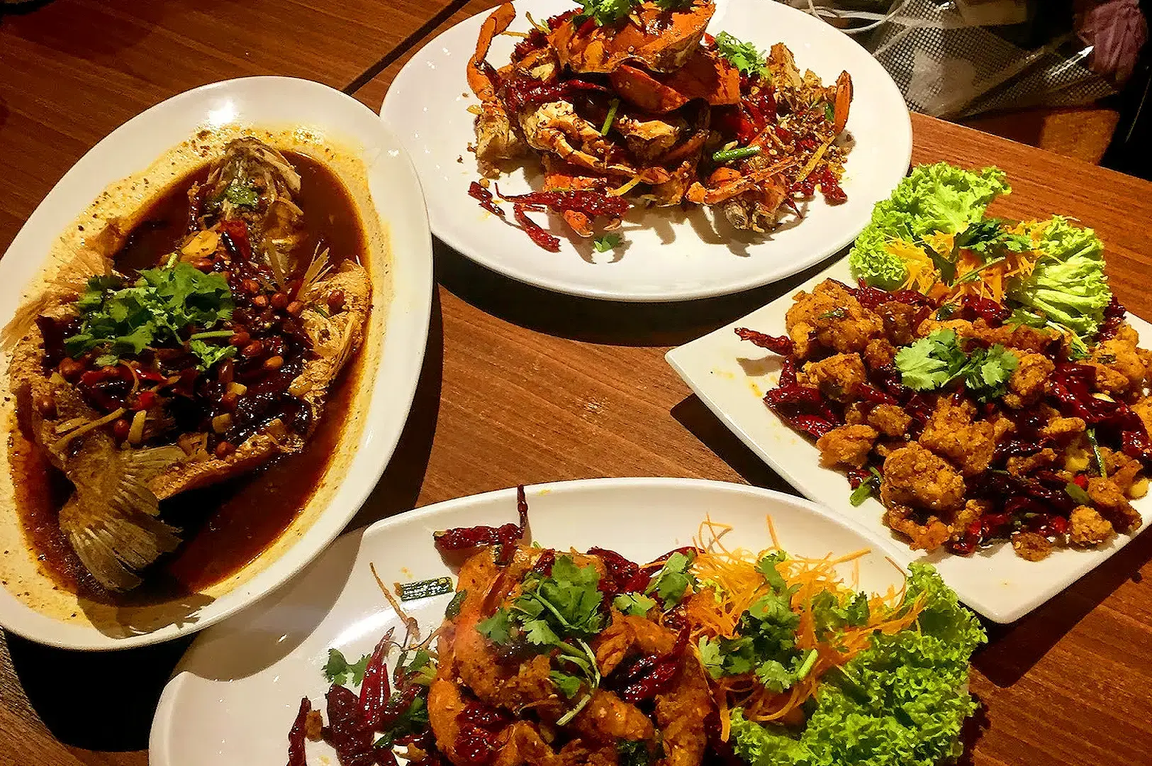 Yassin Kampung Seafood Singapore spread featuring spicy seafood dishes, fried chicken, fish and sambal-style cuisine