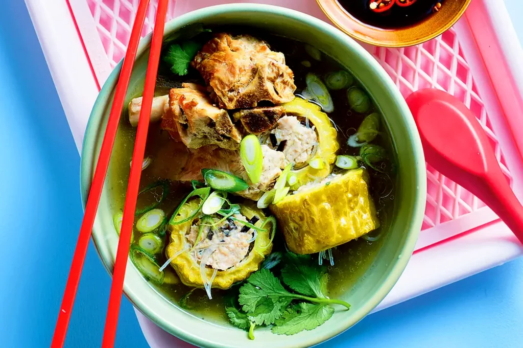 Burmese-style bitter melon soup with stuffed bitter melon, pork, glass noodles, scallions and fresh cilantro in a clear broth
