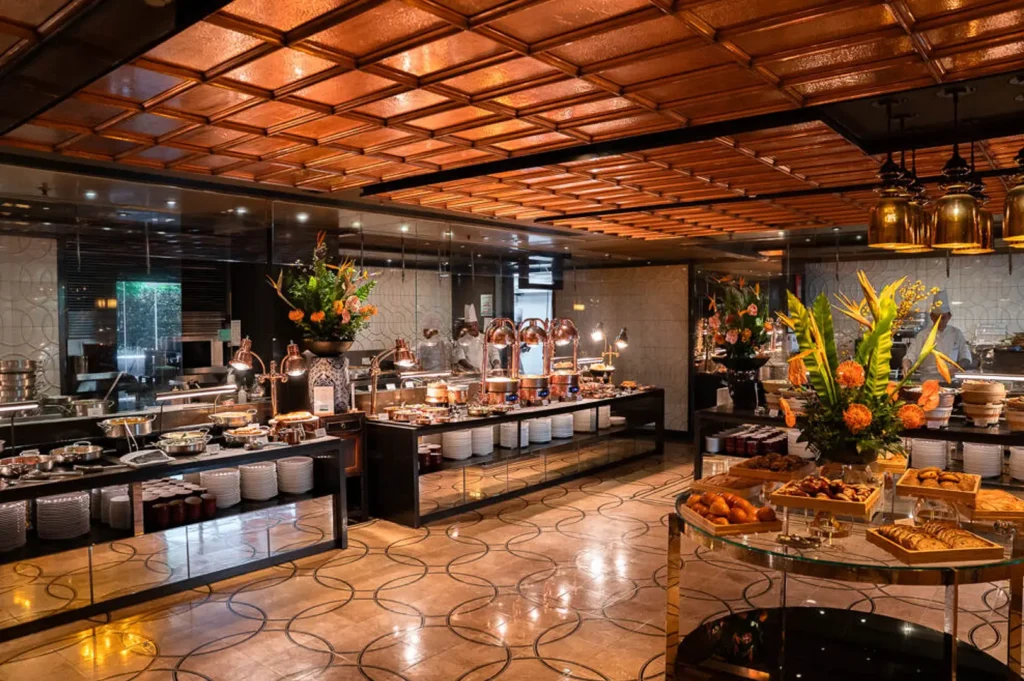 Colony restaurant Singapore buffet dining area with carving station, food displays and luxurious interior