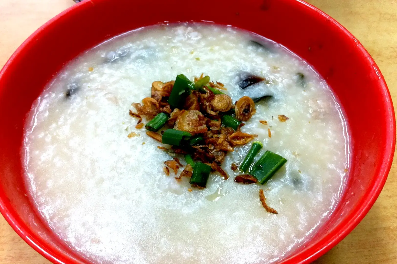 Tiong Shian Porridge Centre Singapore plain rice porridge topped with fried shallots and spring onions
