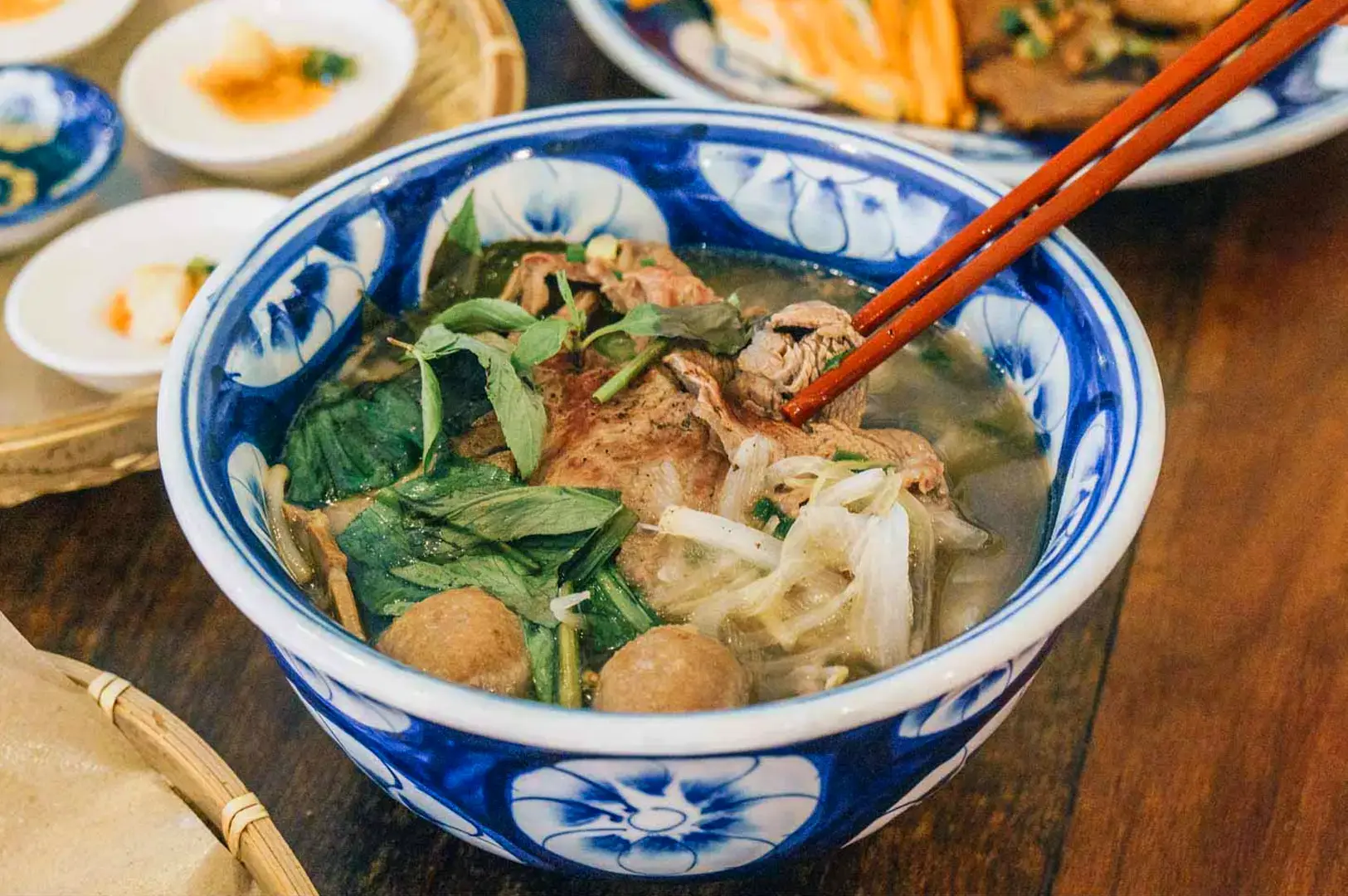 Vietnamese beef noodle soup with fresh herbs and vegetables served at Co Chung Restaurant Singapore