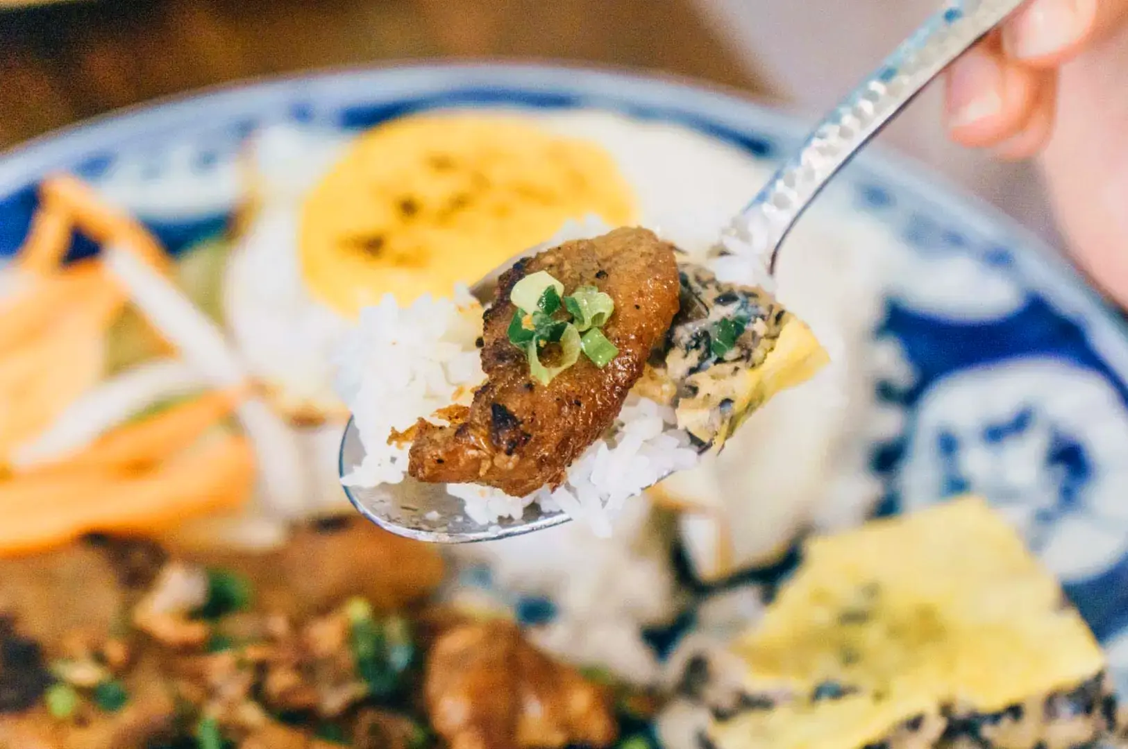 Vietnamese rice dish with grilled meat, herbs and traditional side dishes at Co Chung Restaurant