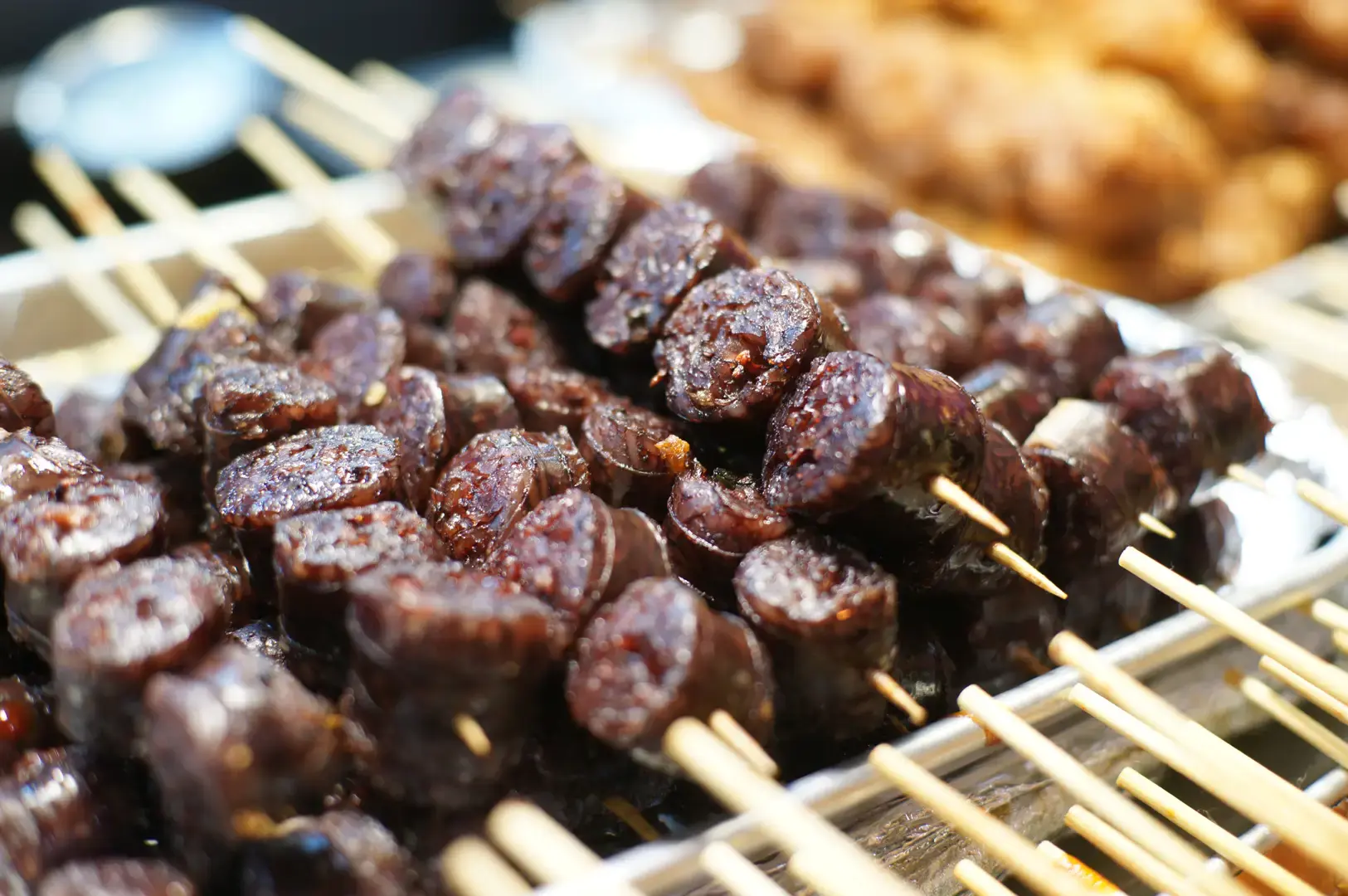Grilled Korean blood sausage skewers at a traditional Korean street food stall