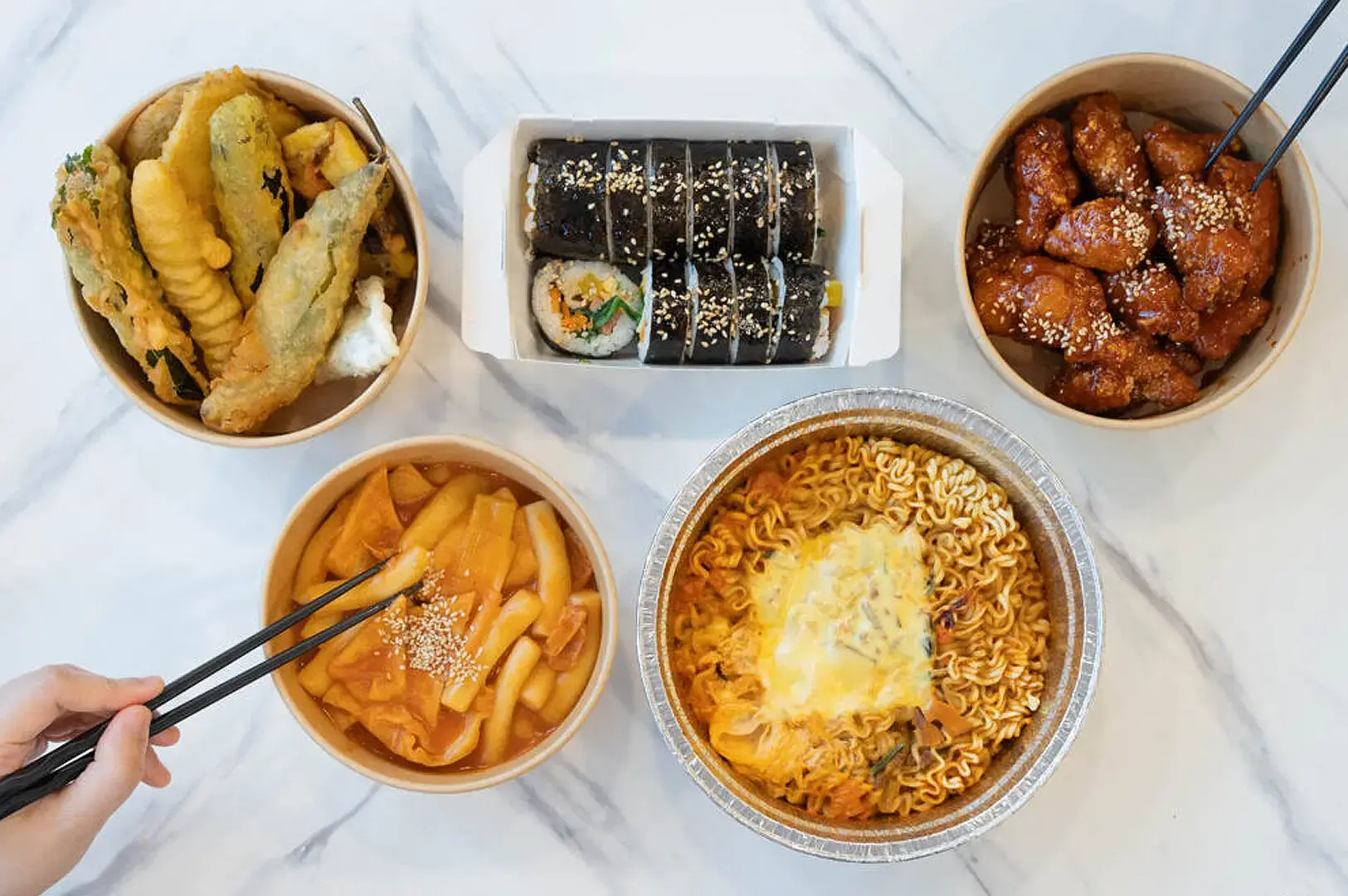 Seoul Bunsik Funan Korean street food spread with tteokbokki, kimbap, fried chicken and Korean ramen