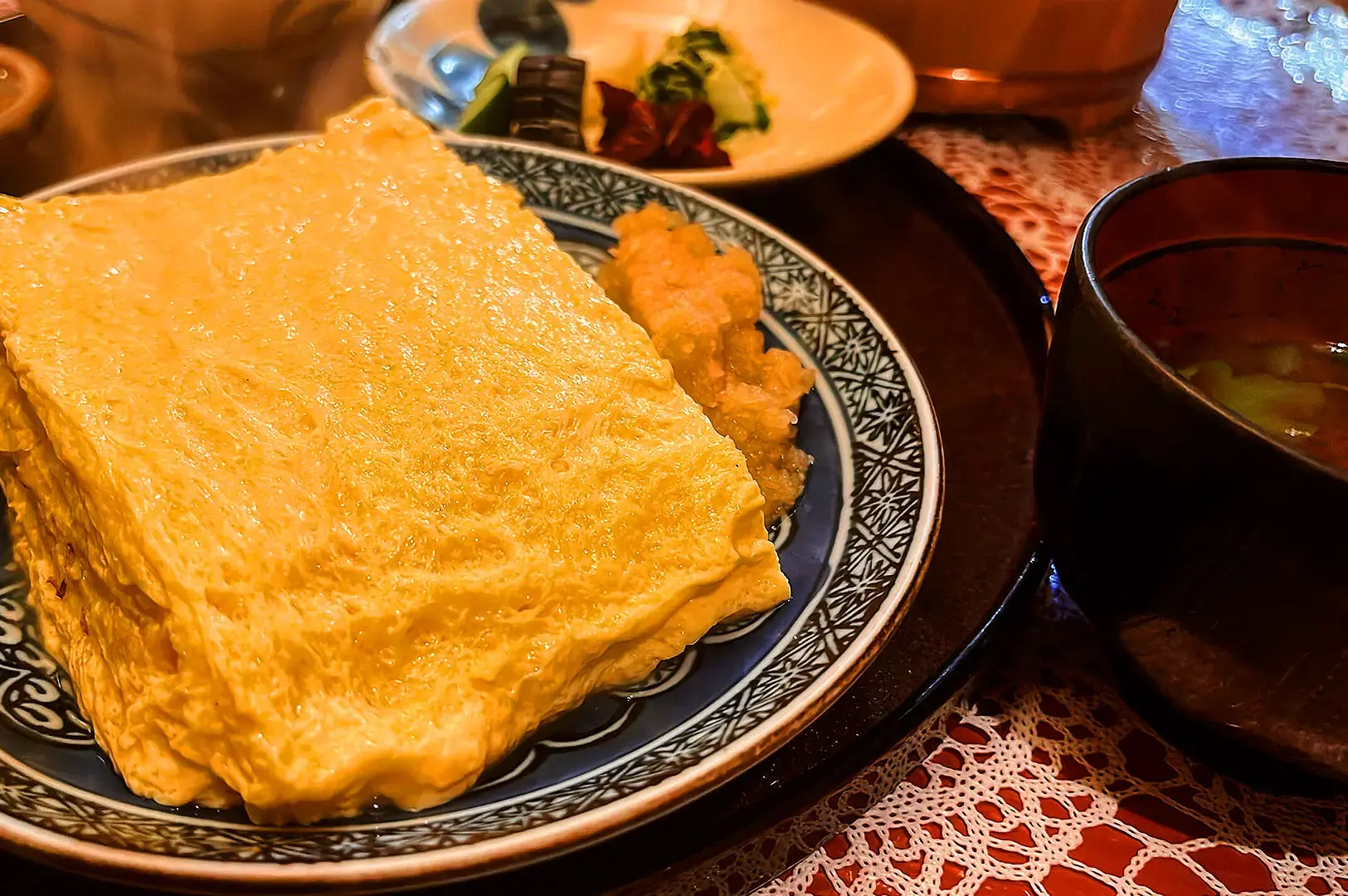 Thick dashimaki tamago Japanese rolled omelette served with Japanese side dishes and miso soup