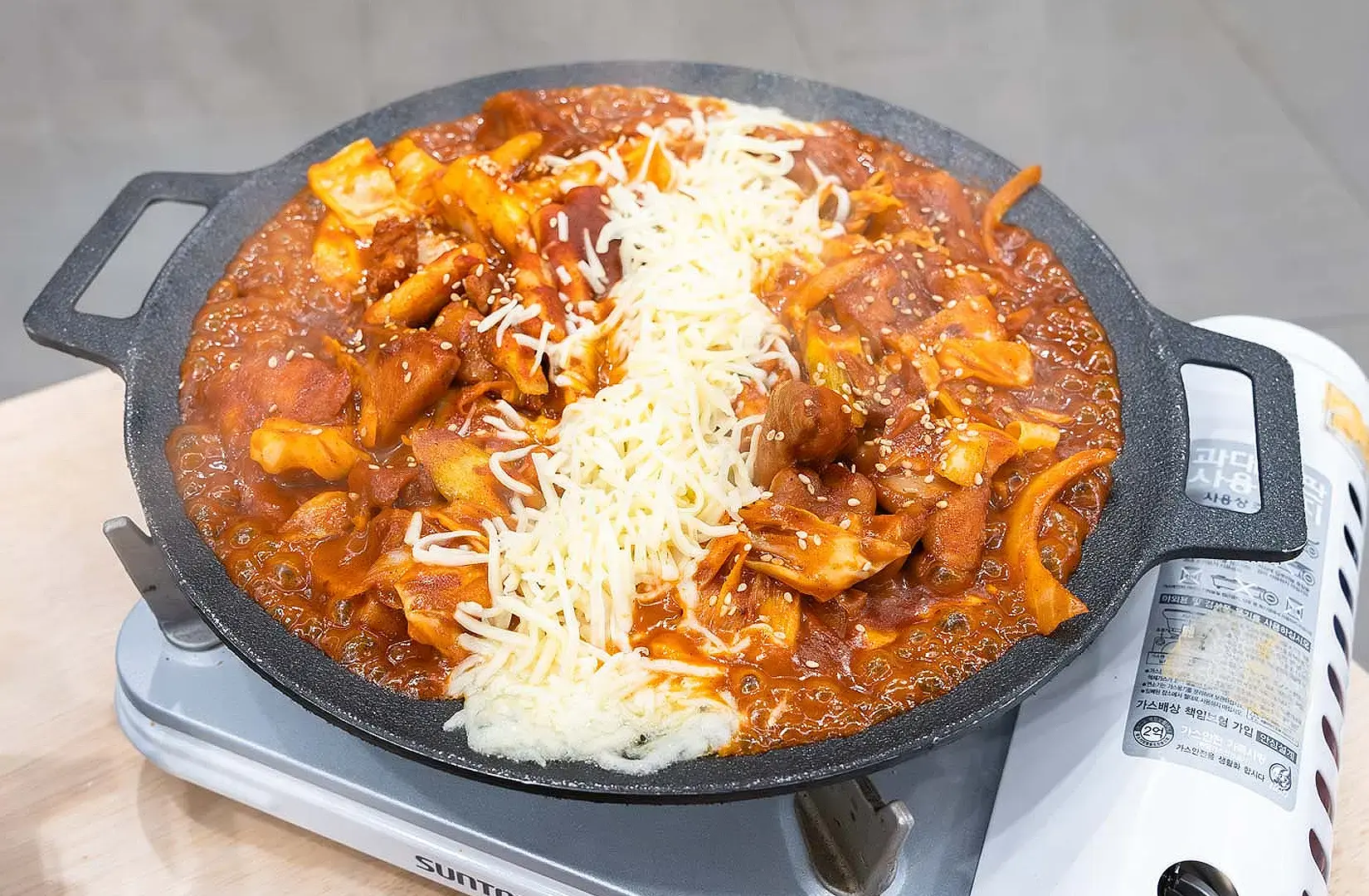 Korean spicy chicken and cheese dish served on a hot plate at a halal Korean restaurant in Singapore