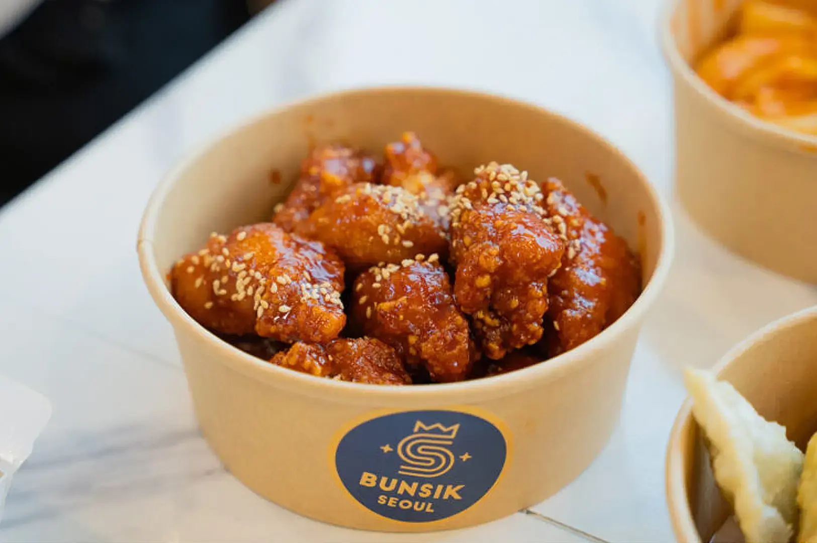 Seoul Bunsik Funan Korean fried chicken bites topped with sesame seeds