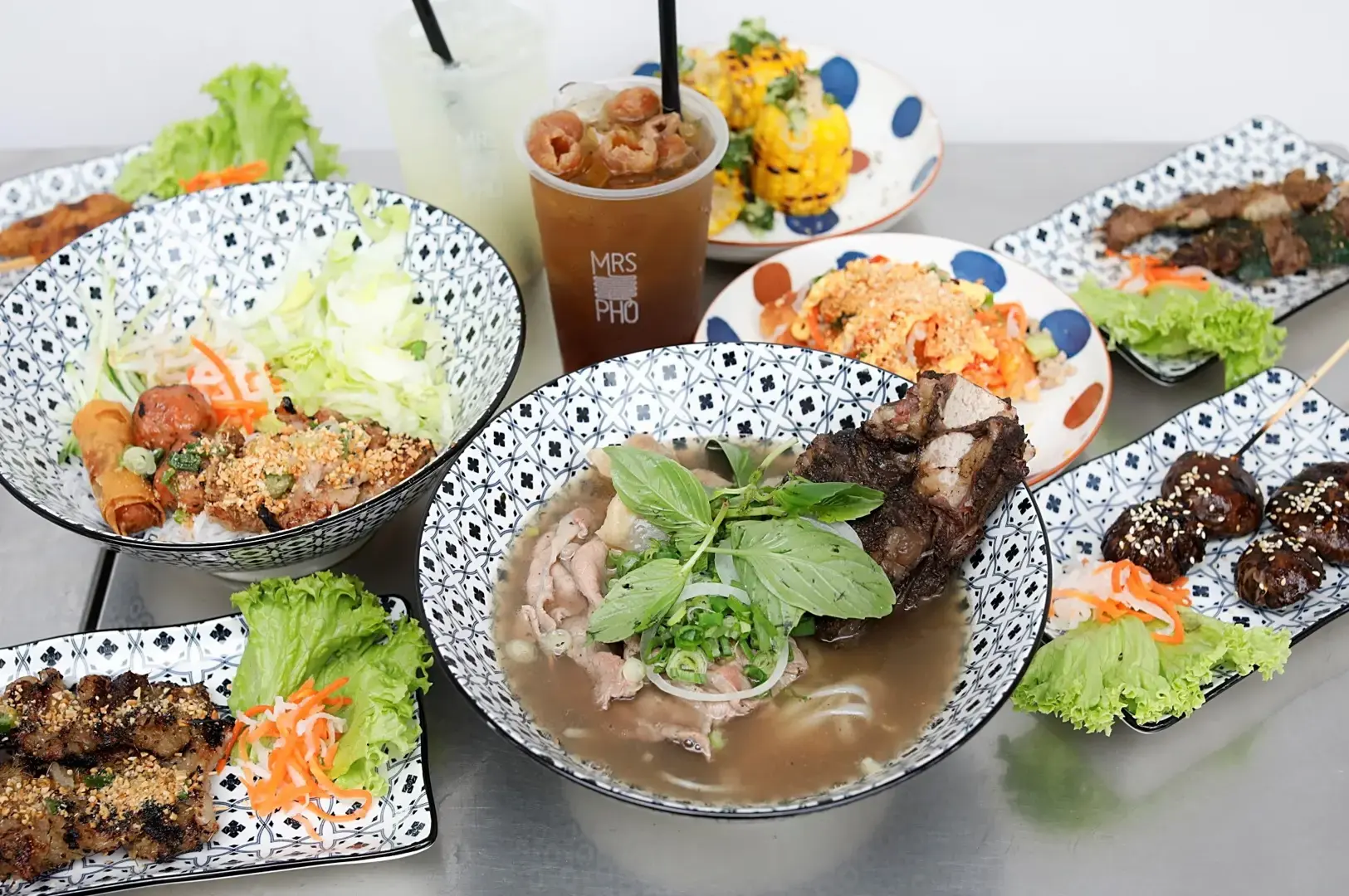 Mrs Pho Somerset Singapore Vietnamese food spread with pho, grilled meats, rice dishes and fresh herbs